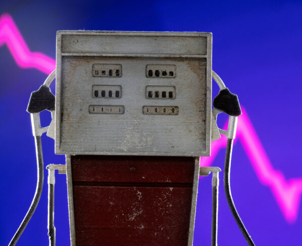 Model of petrol pump is seen in front of decreasing stock graph in this illustration. REUTERS/Dado Ruvic/Illustration