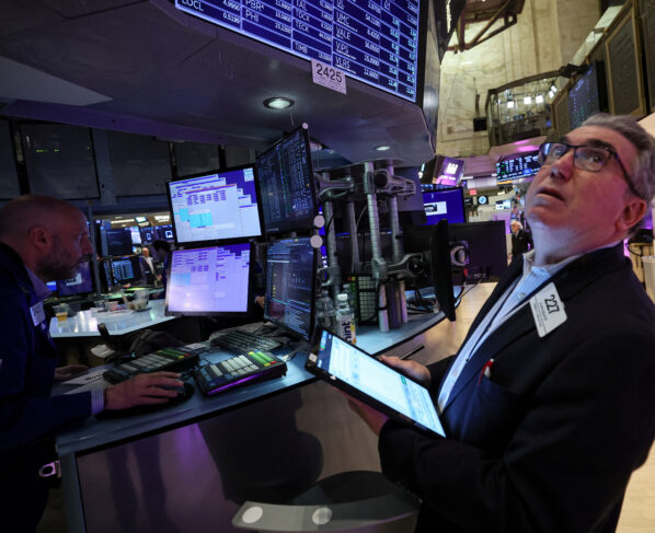 Traders work on the floor of the New York Stock Exchange (NYSE) in New York City, U.S. REUTERS/Brendan McDermid