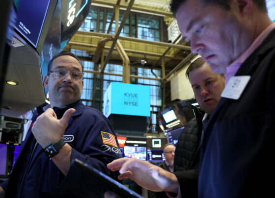 FILE PHOTO: Traders work on the floor of the New York Stock Exchange (NYSE) in New York City. REUTERS/Brendan McDermid