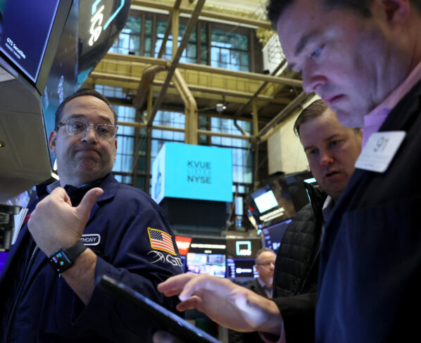 FILE PHOTO: Traders work on the floor of the New York Stock Exchange (NYSE) in New York City. REUTERS/Brendan McDermid